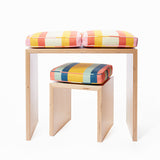 Small bench-desk shown with Small Stripes cushions in Sunshiny Day.  Also shown is the child’s stool with the Small Stripes cushion in Surf Van. Cushions sold separately.